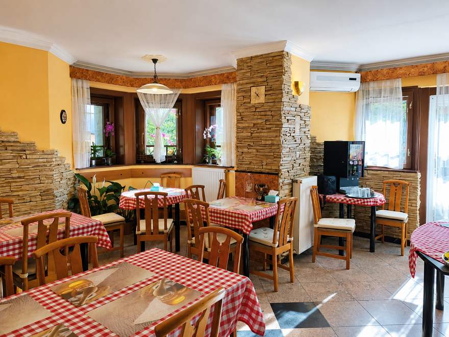 Cozy breakfast room with tables set for a continental buffet