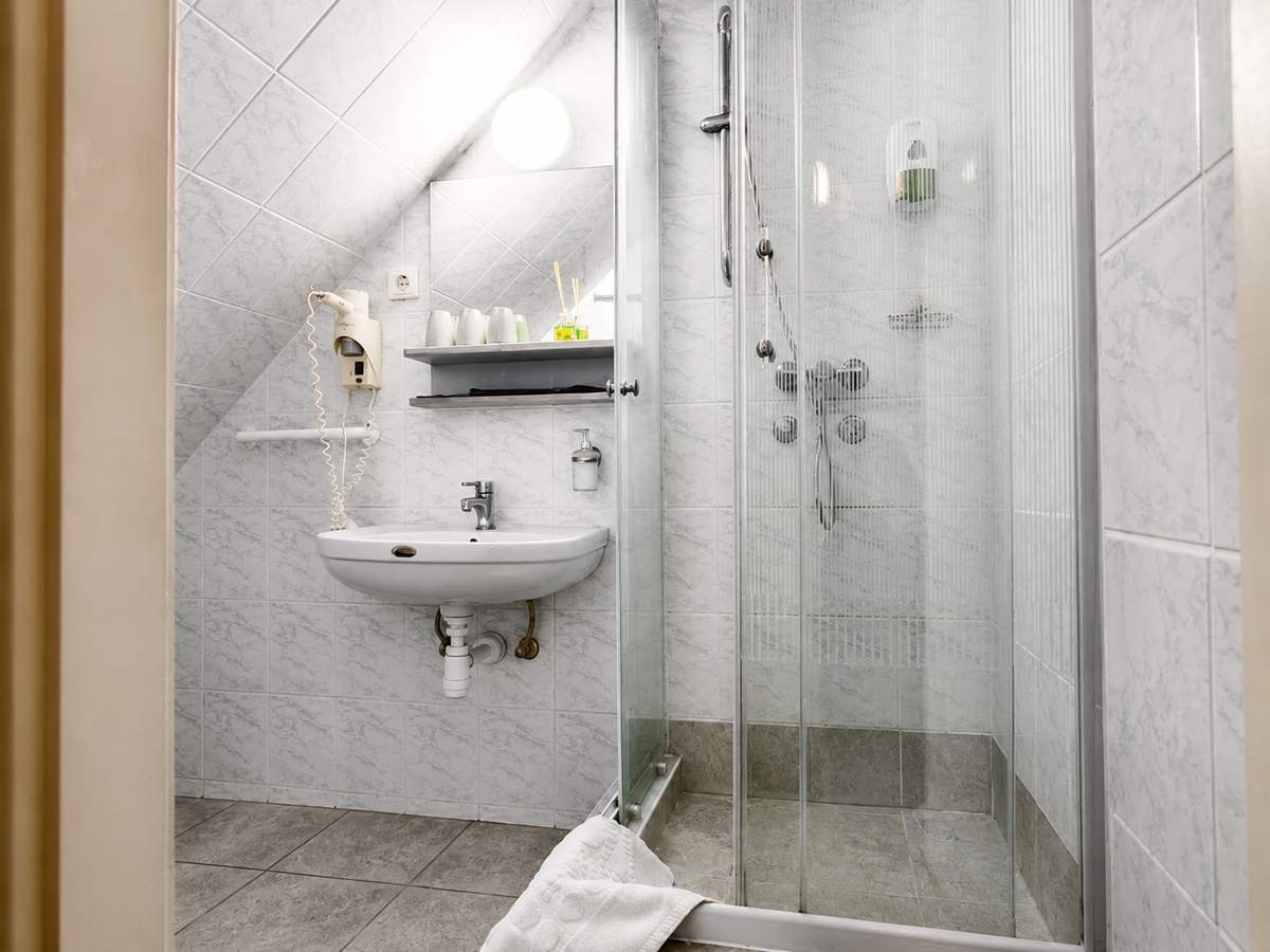Private bathroom with a modern shower cabin in a guest room