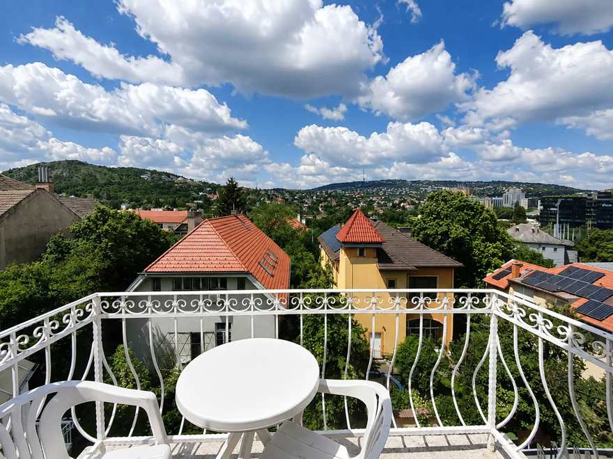 Private balcony overlooking the inner garden at the hotel in Buda