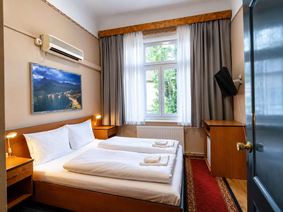 Bright air-conditioned guest room with a work desk at Villa Kristal Hotel