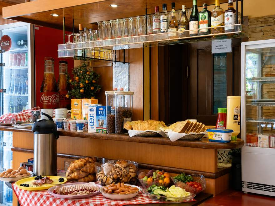 Continental breakfast table with bread, fruit and coffee at the villa